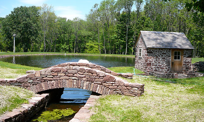 Stone springhouse and stone bridge over small creek